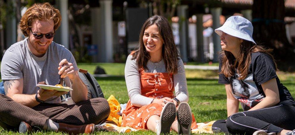 three students on grass